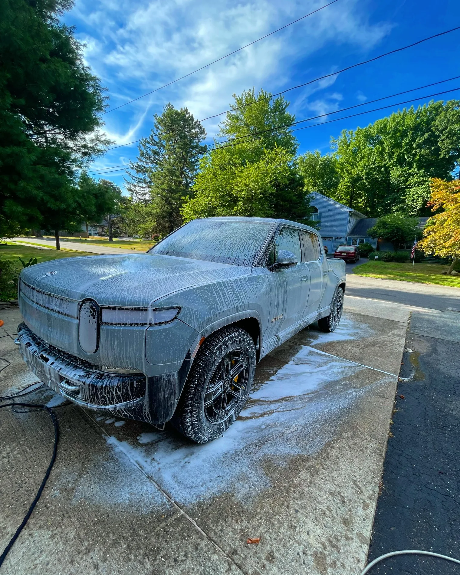 Rivian truck covered in foam during exterior wash